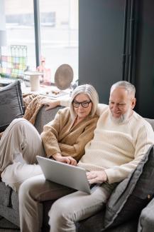 People sitting on couch with laptop