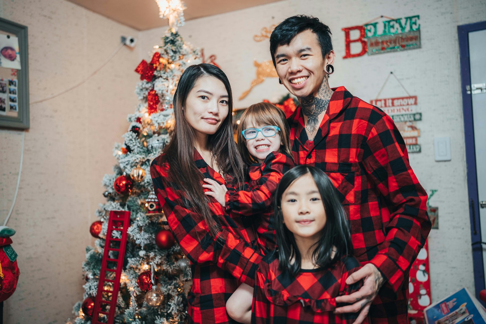 Photo by Kadyn Pierce a family poses for a picture in front of a christmas tree